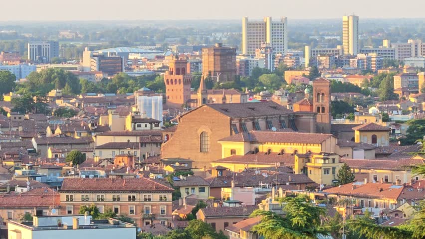 Bologna cityscape showcasing the historic downtown with its ancient buildings, prominent churches, and the iconic Asinelli and Garisenda towers rising above the medieval rooftops in Italy