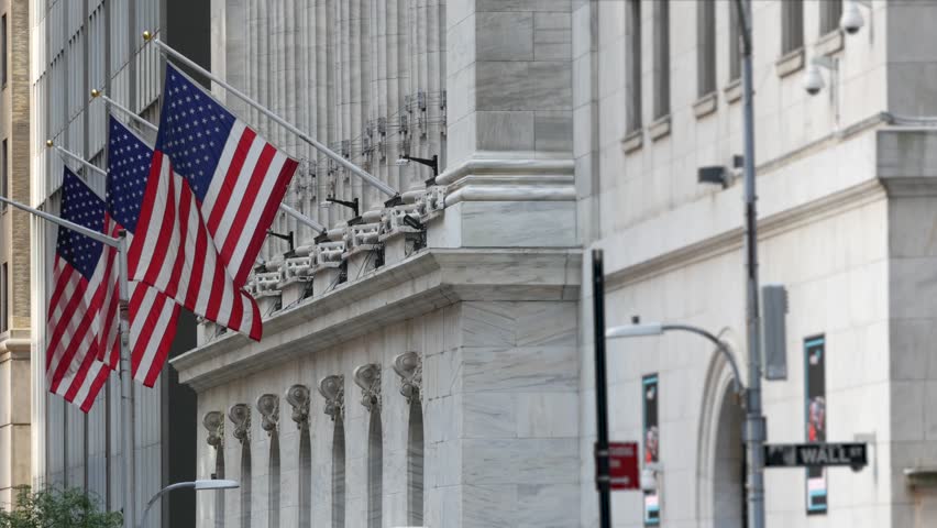 New York City Lower Manhattan Downtown Financial District, United States. Wall Street sign, stock exchange market building 1903, FiDi. American USA flag on facade. Trading finance and business concept