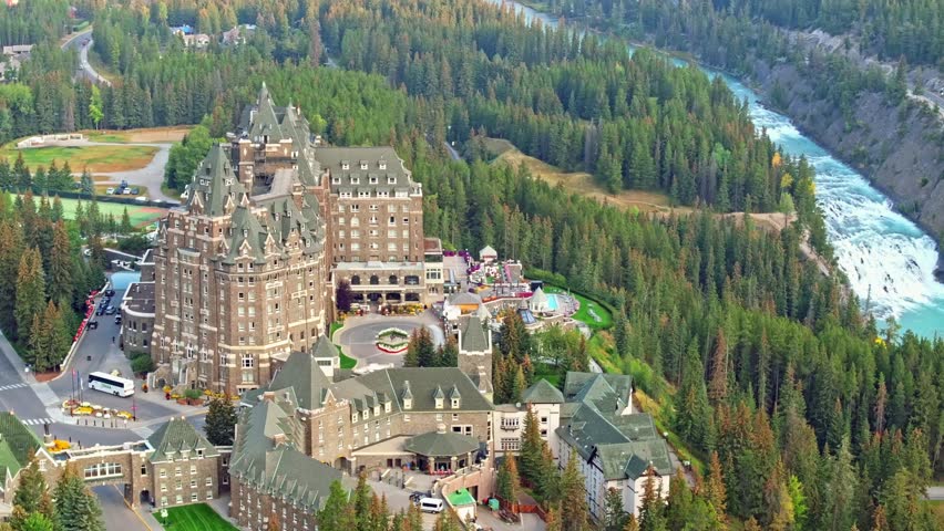 Capturing Banff Avenue, Bow river with turquoise water, picturesque townscape surrounded by forested valleys and mountain ranges in Alberta, Canada.
