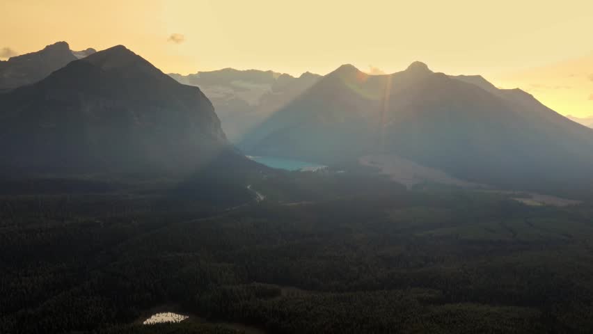 Cinematic shot revealing a beautiful Louise lake, surrounded by tall trees and mountains