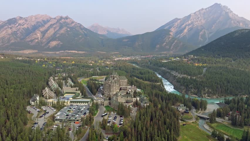 Capturing Banff Avenue, Bow river with turquoise water, picturesque townscape surrounded by forested valleys and mountain ranges in Alberta, Canada.