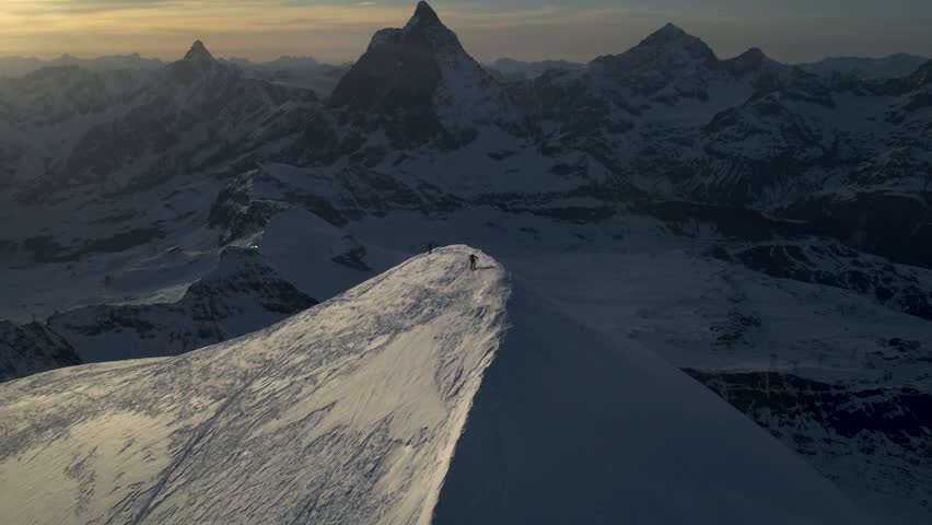 Drone aerial of ski mountaineers in Zermatt, Switzerland. 

Breathtaking Swiss Alps scenery showcasing winter adventure, backcountry skiing, alpine wilderness, and outdoor exploration.