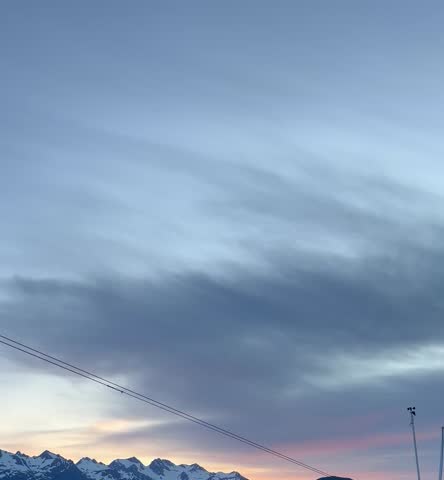 Twilight over snowy peaks with dusk sky and power lines

Dusk view of snow covered mountain peaks under twilight sky with soft clouds and power lines, cold scenic landscape in wilderness
