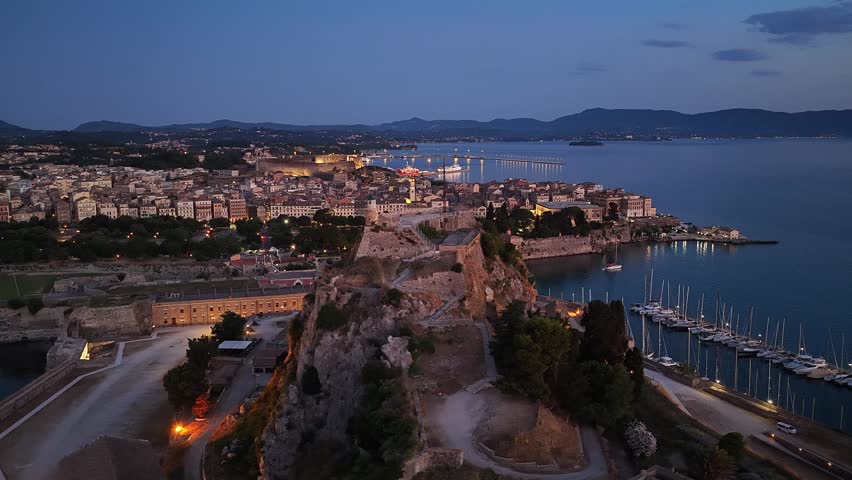 Corfu Old Fortress and Town lights from above at night