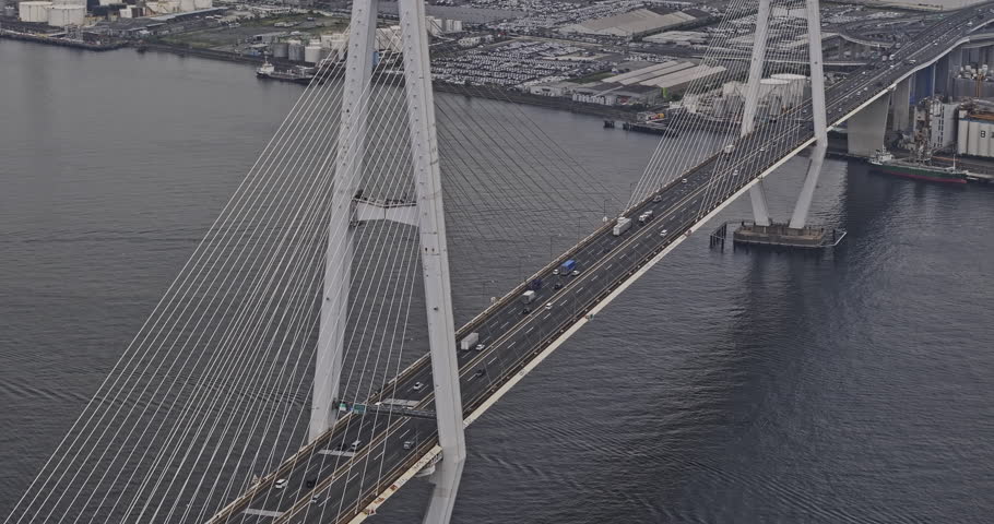 Nagoya Japan Aerial v10 zoomed flyover port harbor capturing Meiko-Chuo Bridge traffic, views of Shiomicho industrial sector and Minato ward cityscape - Shot with 8k camera