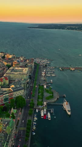 Establishing shot of Geneva city. Aerial view of the Swiss lake town. Rooftops of houses and the lake bay