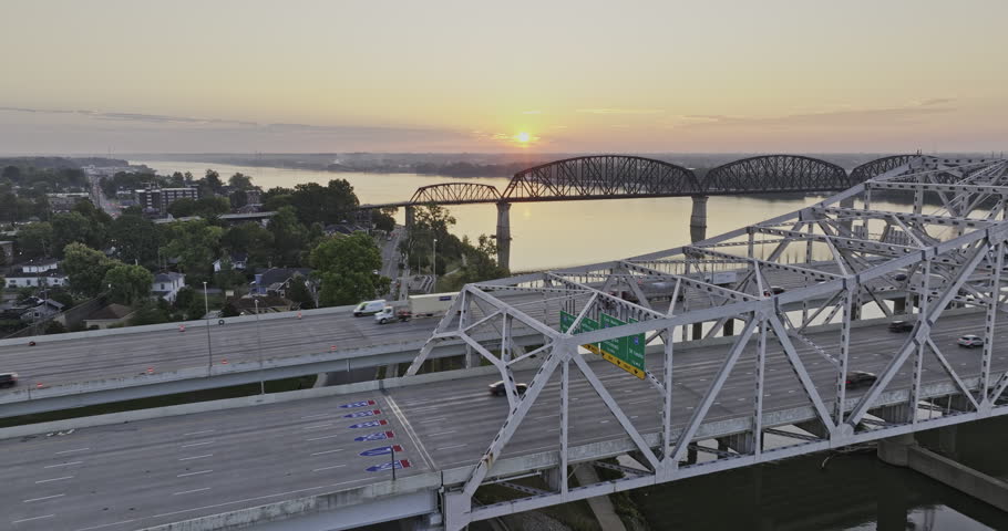 Louisville Kentucky Aerial v55 drone low flyover interstate freeway and big four bridges over the Ohio river with beautiful sun rising on the horizon - Shot with 5k Camera - Sept 26th 2023