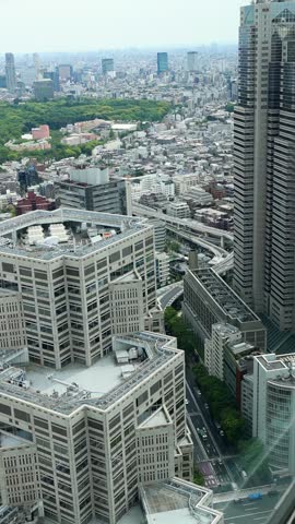 Expansive vertical view of Tokyo skyline, Japan, with dense city blocks, tall buildings and modern downtown atmosphere. Travel destination and contemporary city concept