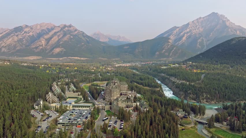 Capturing Banff Avenue, Bow river with turquoise water, picturesque townscape surrounded by forested valleys and mountain ranges in Alberta, Canada.