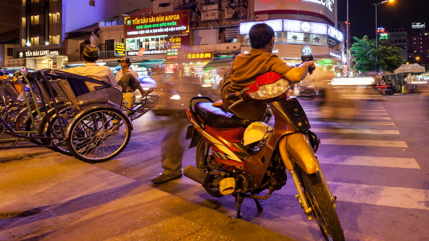 HO CHI MINH CITY - JUNE 8: Panning Timelapse view of vietnamese moto taxi driver