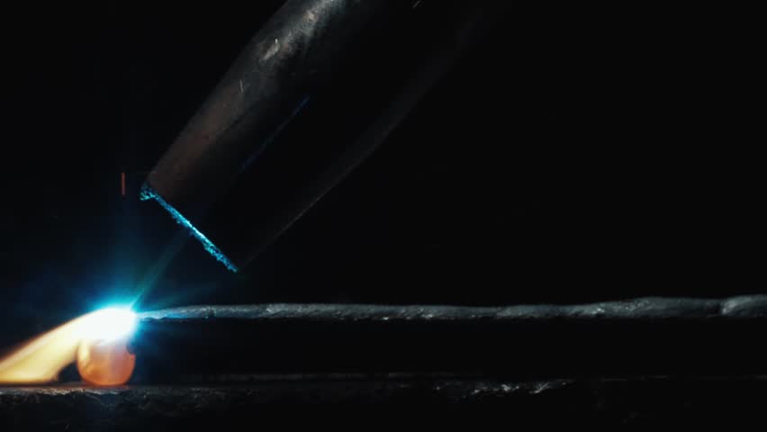 Close Up Of Heavy Industrial Metal Welding Action Performing On Massive Structural Frame Part. Reliable Manufacturing Assembly Line Operations Inside Engineering Workshop Facility Slow Motion 4k