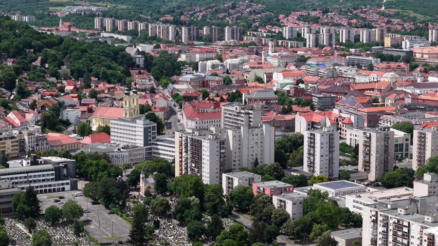 This high angle view captures the urban landscape of Miskolc, Hungary, highlighting the architectural contrast between history and modernity.