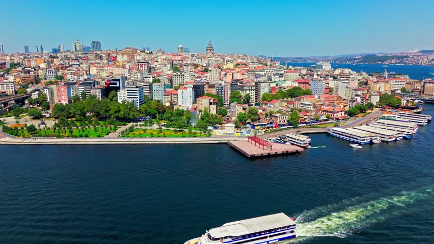 Aerial view of the Bosphorus in Istanbul, Turkey. Boats, blue water and the city coastline create a scenic waterfront travel view.