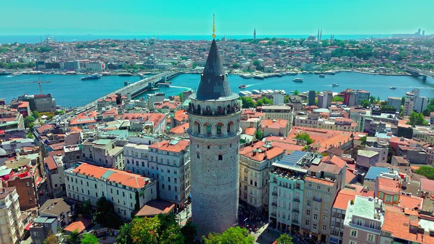 Aerial close view of Galata Tower in Istanbul, Turkey. The famous landmark overlooks the Golden Horn, Bosphorus and crowded cityscape.