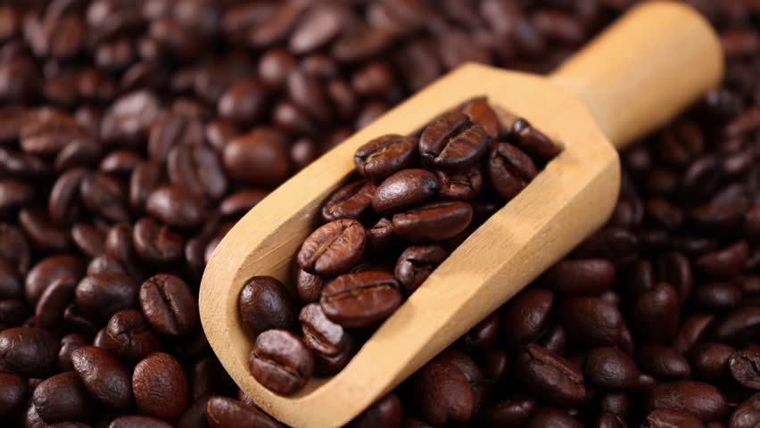 Roasted coffee beans in a wooden scoop	