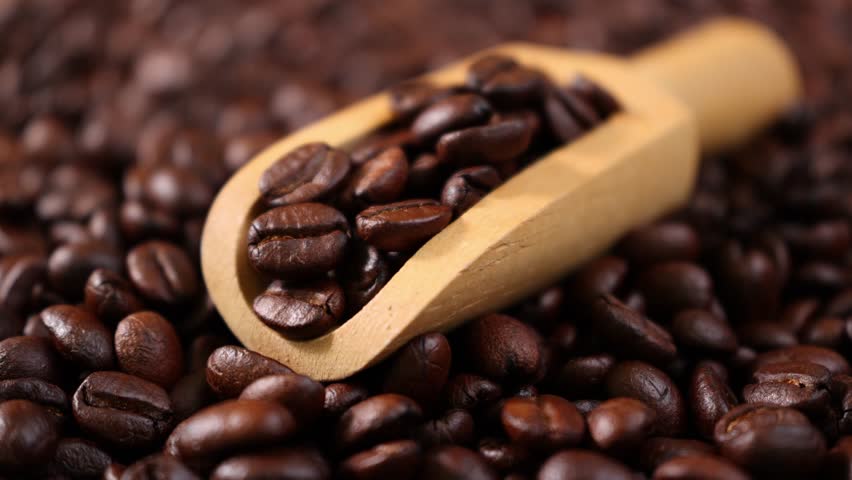 Roasted coffee beans in a wooden scoop	