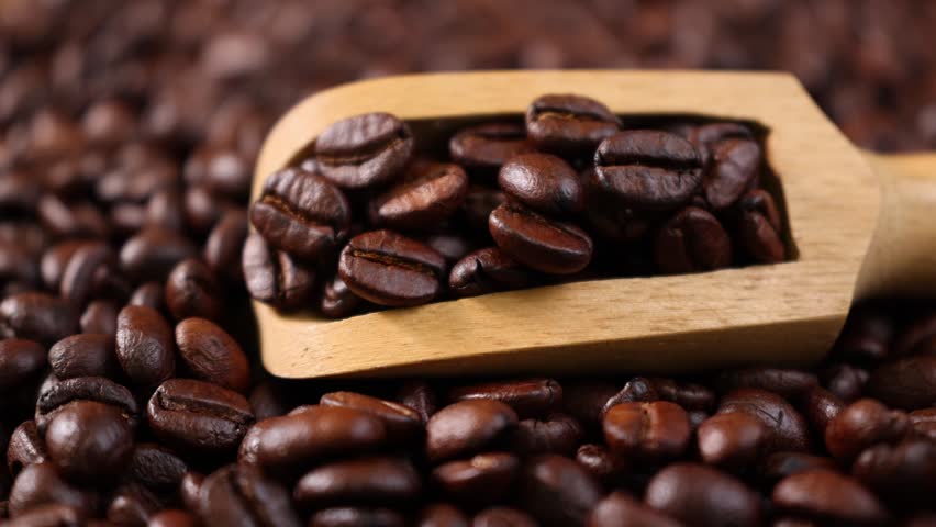 Roasted coffee beans in a wooden scoop	