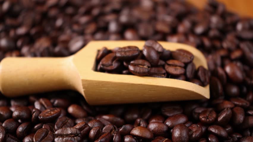Roasted coffee beans in a wooden scoop	