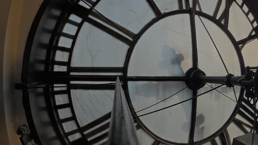 Interior timelapse of Daniels and Fisher Tower looking toward the frosted clock face as afternoon fades to sunset, clock hands move, and interior lights illuminate.