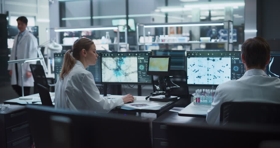 Team of Scientists Work on Drug Development and Disease Treatment in a Modern Medical Research Facility, Analyzing Molecular Structures, Microscope Samples, and Brain Scans on Advanced Computer Monitors.
