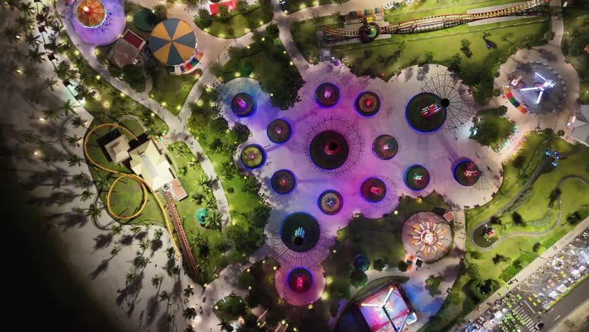 Top-down aerial view of illuminated Vinhomes Grand park in Ho Chi Minh city at night, Saigon, Vietnam.