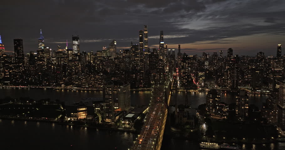 NYC New York Aerial v356 drone flyover Queensboro Bridge over East river capturing illuminated Roosevelt Island and dusk cityscape of Midtown Manhattan - Shot with 8k camera