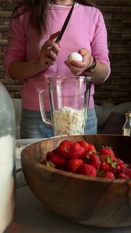 Making Homemade Strawberry Pie by Adding Egg to Cream Filling