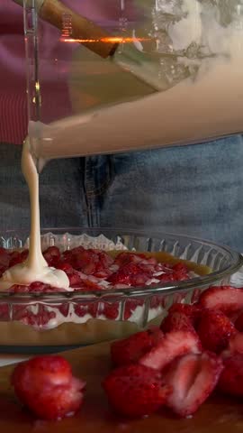 Making Homemade Strawberry Pie by Pouring Cream Filling into Pie Crust