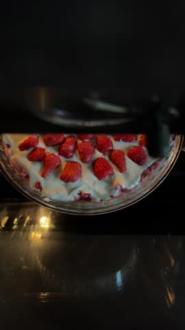 Making Homemade Strawberry Pie by Placing It into the Oven