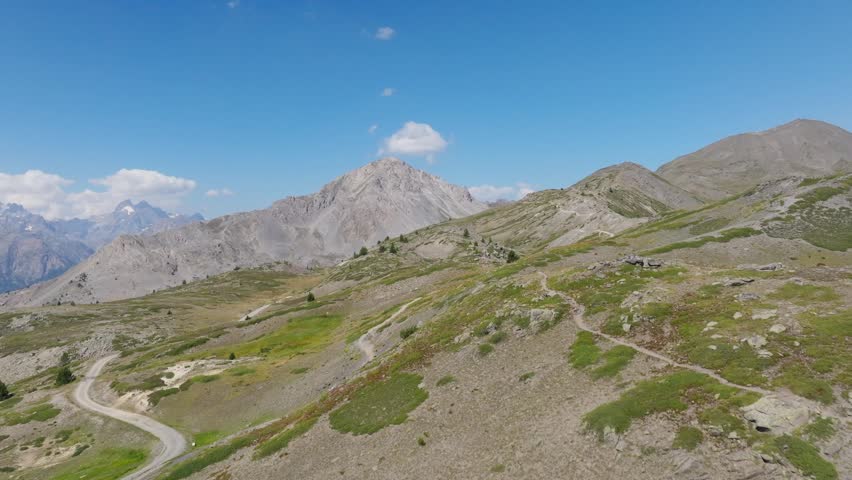 Cinematic aerial drone footage of the French Alps showcasing breathtaking mountain landscapes, dramatic peaks, lush green valleys, dense forests, and pristine alpine nature. Stunning panoramic views c