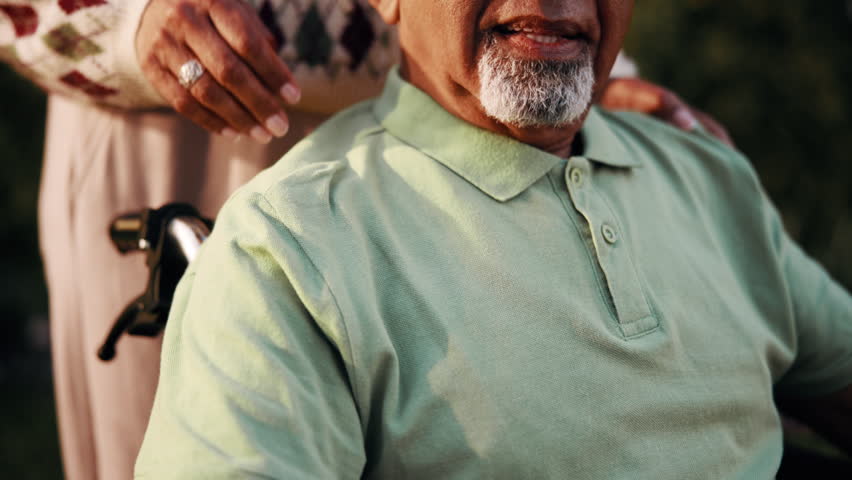 Senior couple, holding hands and love in nature, laughing and elderly man in wheelchair with partner. Outdoor, support and old person with disability, care or bonding with spouse and happy in park