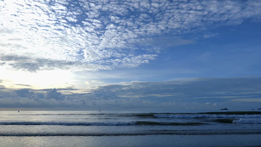 Dramatic Blue Sky with Clouds Over Wide Ocean Horizon and Beach