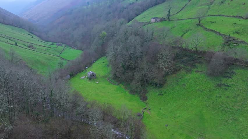 Aerial view from a drone of the winter landscape around the village of Vega de Pas. Pasiegos Valleys region, Cantabria, Spain, Europe