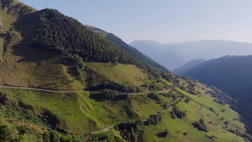Cinematic aerial drone footage of the French Alps showcasing breathtaking mountain landscapes, dramatic peaks, lush green valleys, dense forests, and pristine alpine nature. Stunning panoramic views c