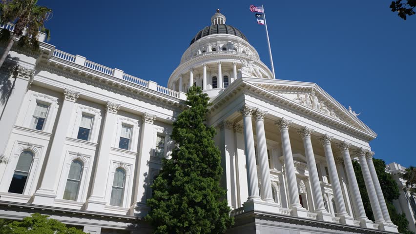 Explore the California State Capitol in Sacramento under the bright sun while noticing its impressive architecture and surroundings