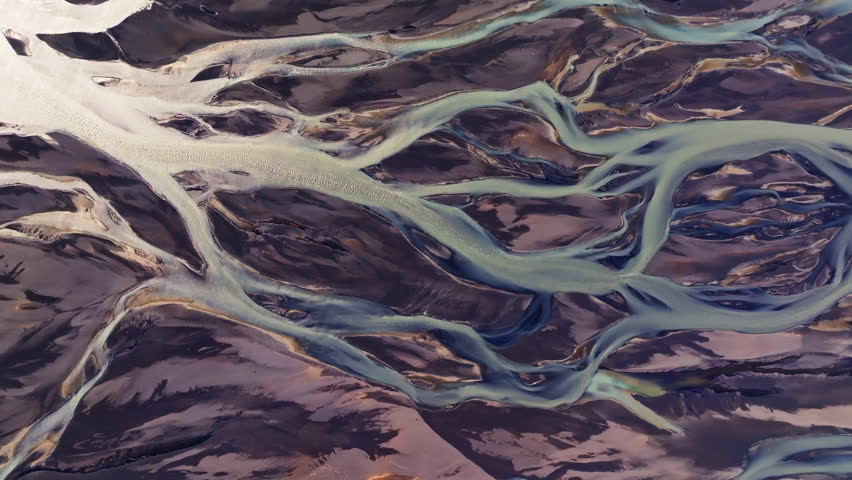 Glacial river delta as waterways create abstract tendrils in landscape. Drone
