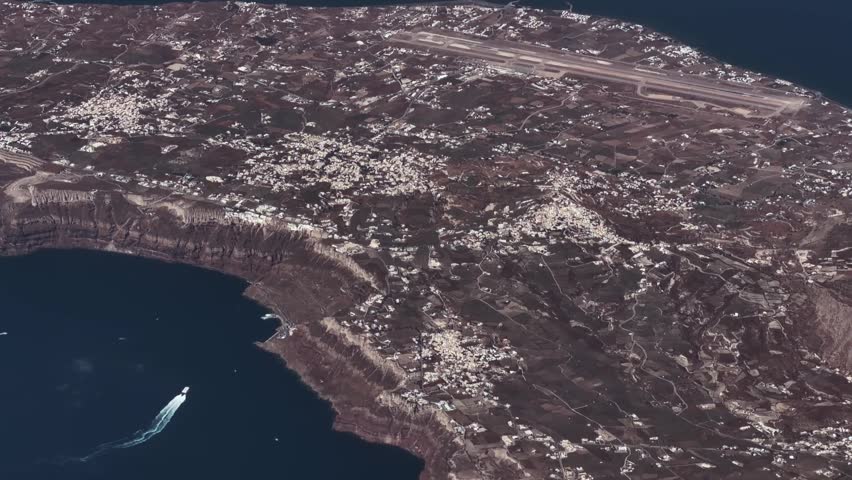 4k aerial video footage - flying along central part of west coast of Santorini, a famous Greek Island in the southern Aegean Sea with Thira the capital of Santorini, Ormos Firon as well as Cruise Ships anchored close to cliffy coastline
