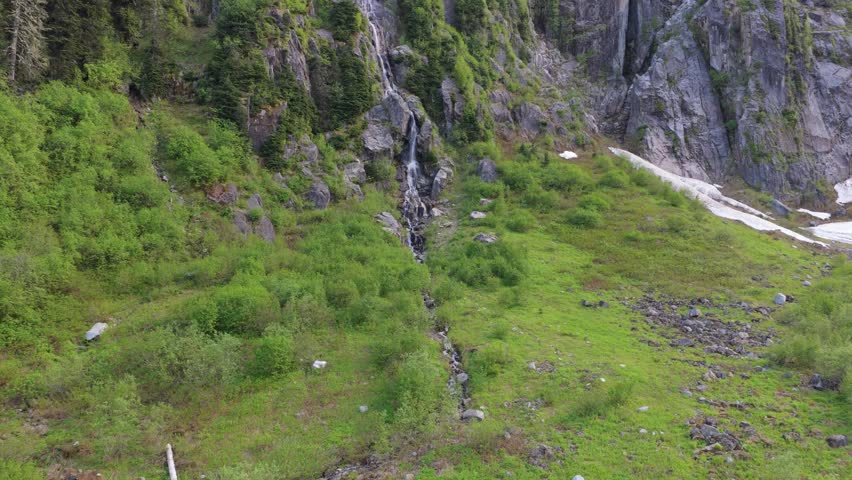 Majestic Waterfall Cascading Down a Steep, Green Mountain Slope in British Columbia, Canada