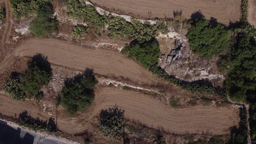 Naxar, Malta 01.07.2026 - Salini Catacombs aerial view of the field. This group of burials is situated in an area known as Ta Latnija. High quality 4k footage