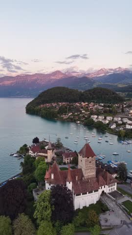 Drone Flying Forward Over Spiez Castle and Lake Thun, Switzerland ,Top view