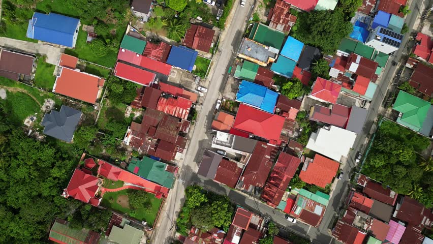 Wide angle aerial shot of CJDC Building and nearby roads in Poblacion III Alfonso Cavite Philippines featuring roadside businesses and a provincial town setting.