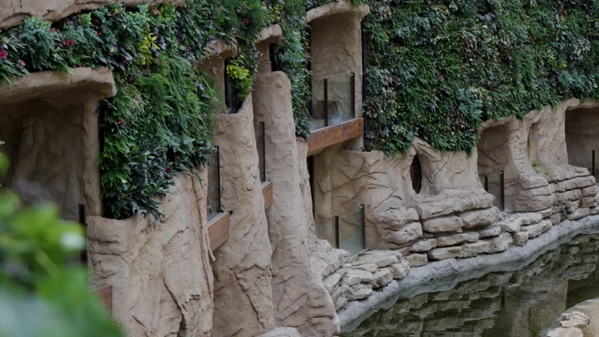 Earthy sculpted facade with living green walls, Brugelette zoo.