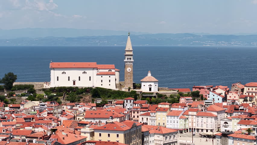 Piran, Slovenia. Drone Shot of St. George Church and Venetian Bell Tower Above Adriatic Sea