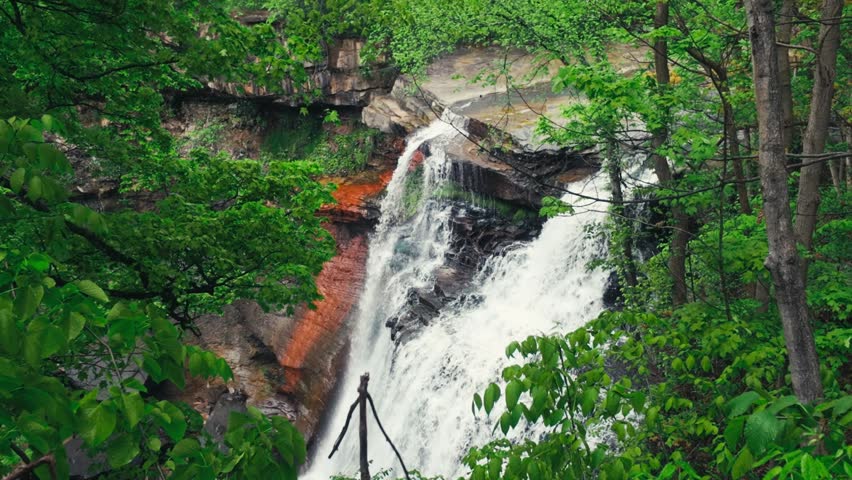 A moving shot of a Brandywine Falls surrounded by forest trees in the frame.