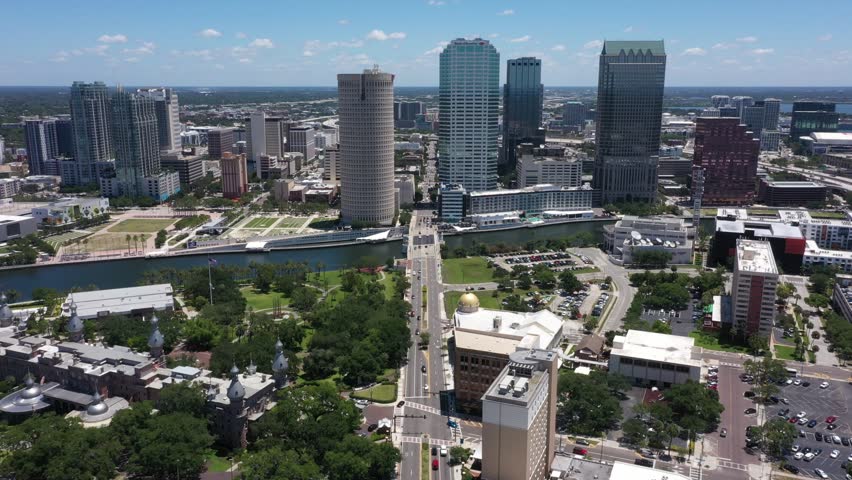 Aerial drone view of downtown Tampa, Florida, where sleek skyscrapers rise beside the Hillsborough River, blending modern city life with the shimmering charm of the Gulf Coast.