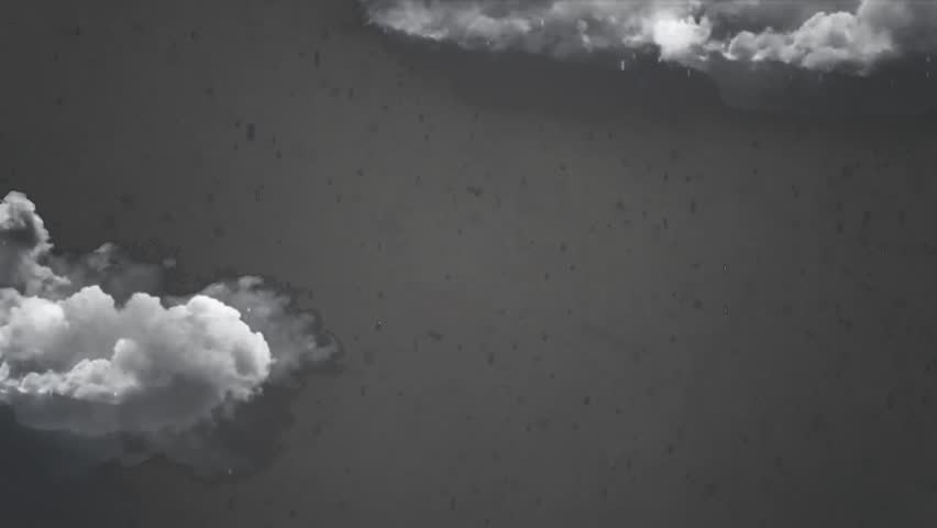Bright fireworks exploding in the dark night sky with soft white clouds.