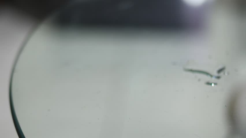 Rack Focus on Water Droplets on Glass Table Surface