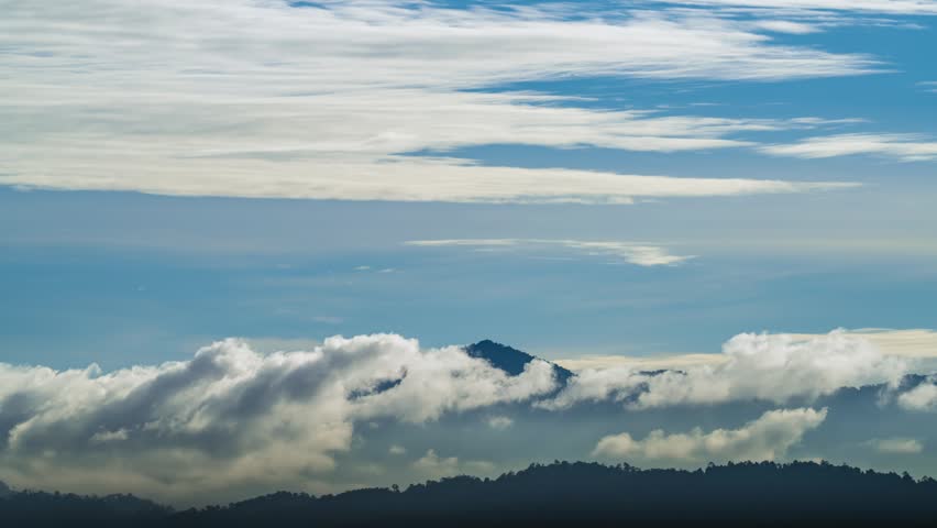 Aerial birds eye view of hazy and misty clouds time lapse at mountain in the morning.