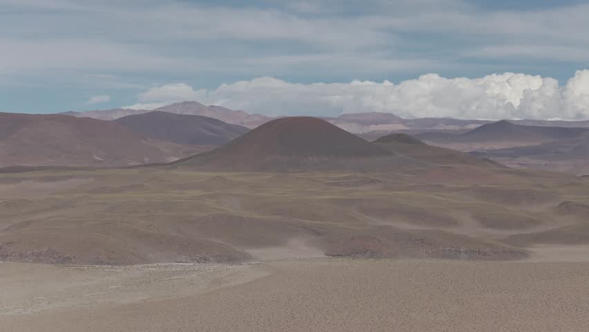 Drone panorama of the Argentine Altiplano with vast desert mountains and winding valley