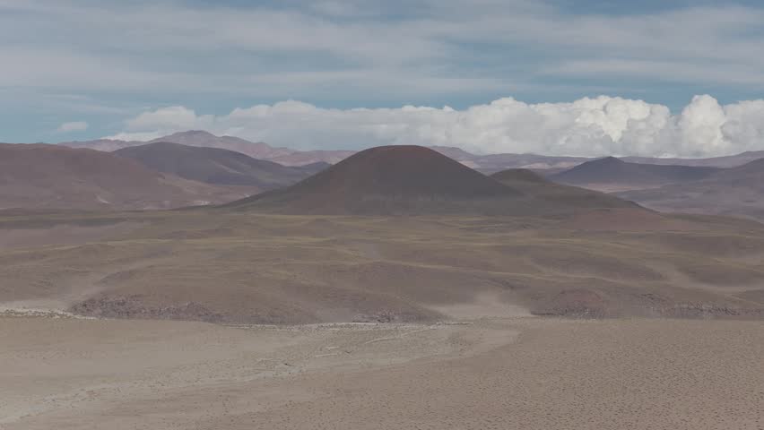 Drone panorama of the Argentine Altiplano with vast desert mountains and winding valley